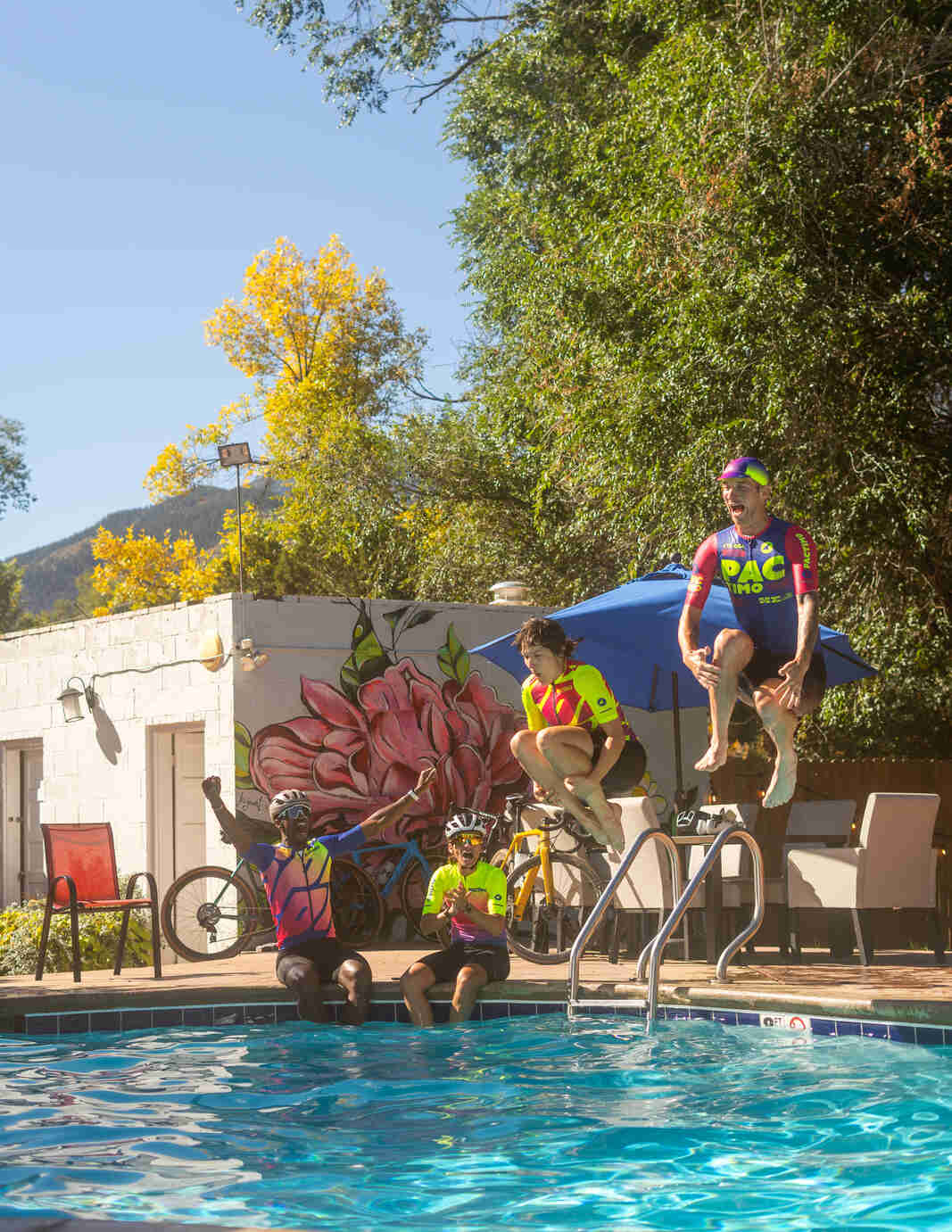 Cyclists Jumping in a Pool at Buffalo Bike Lodge