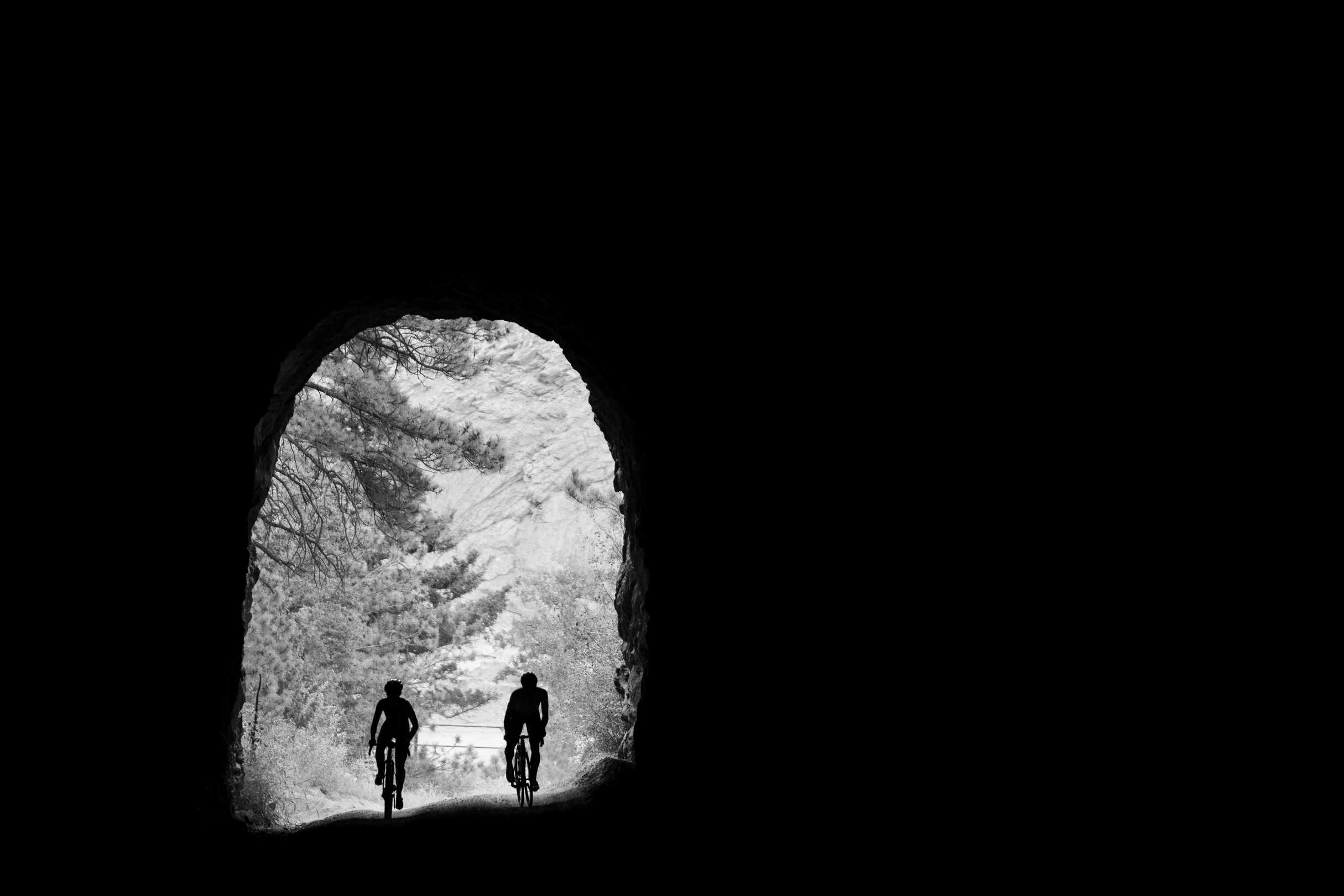Cyclists riding through Gold Camp Road Tunnel