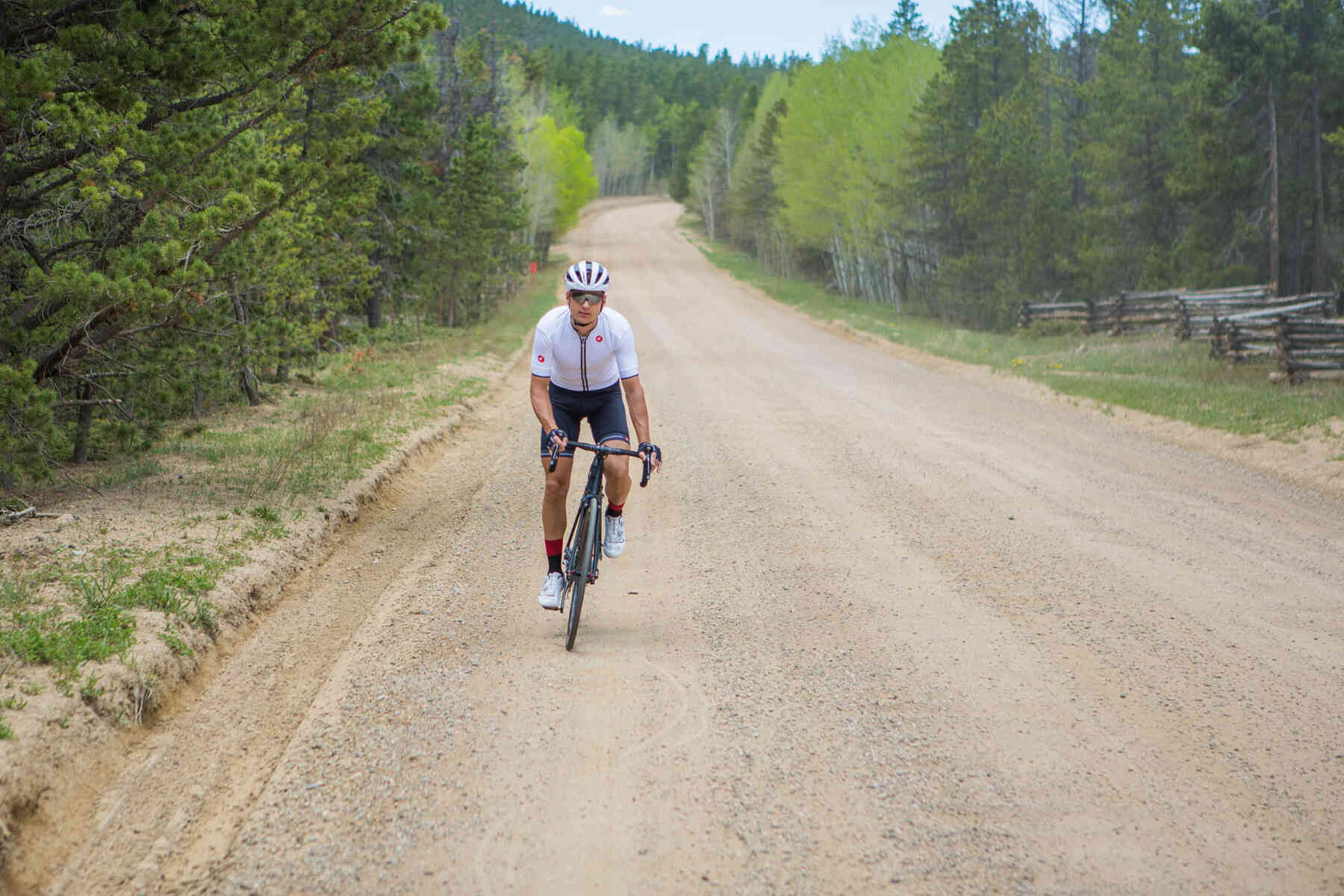 Man Riding a Road Bike on Gravel