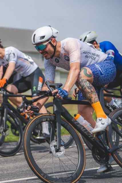 Cyclist racing in Cumberland Valley Collective team cycling kit made by Pactimo