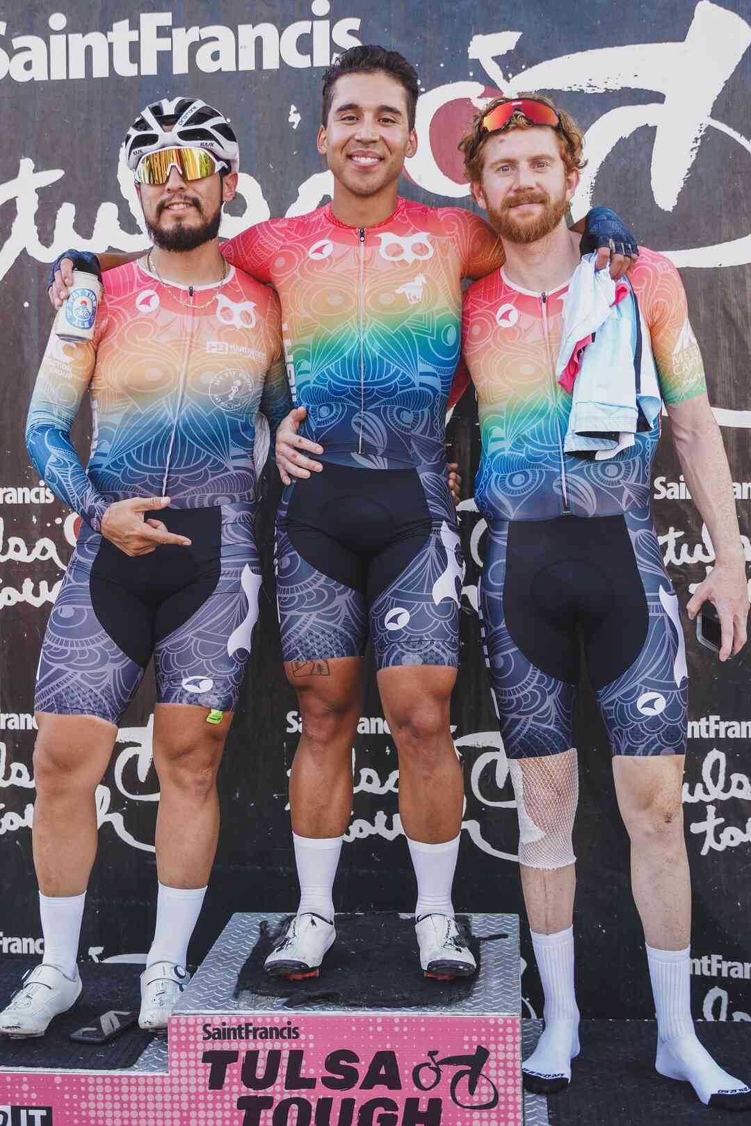 Cycling team on podium wearing Pactimo Custom Kits