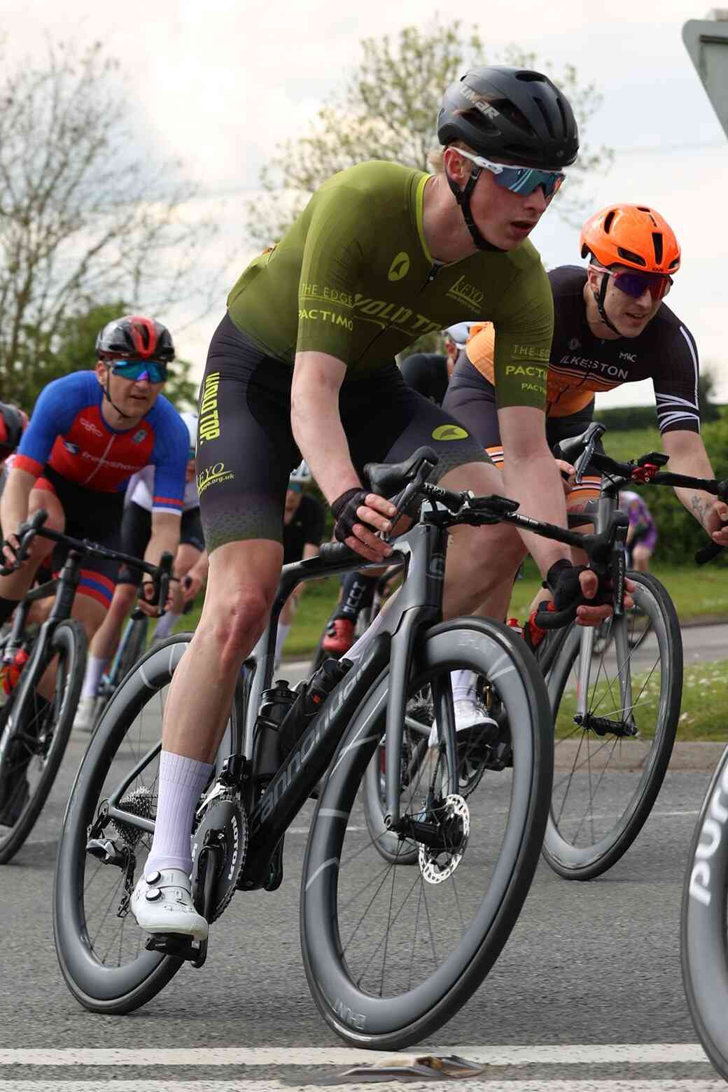 Cyclist racing criterium in a Pactimo Custom Kit