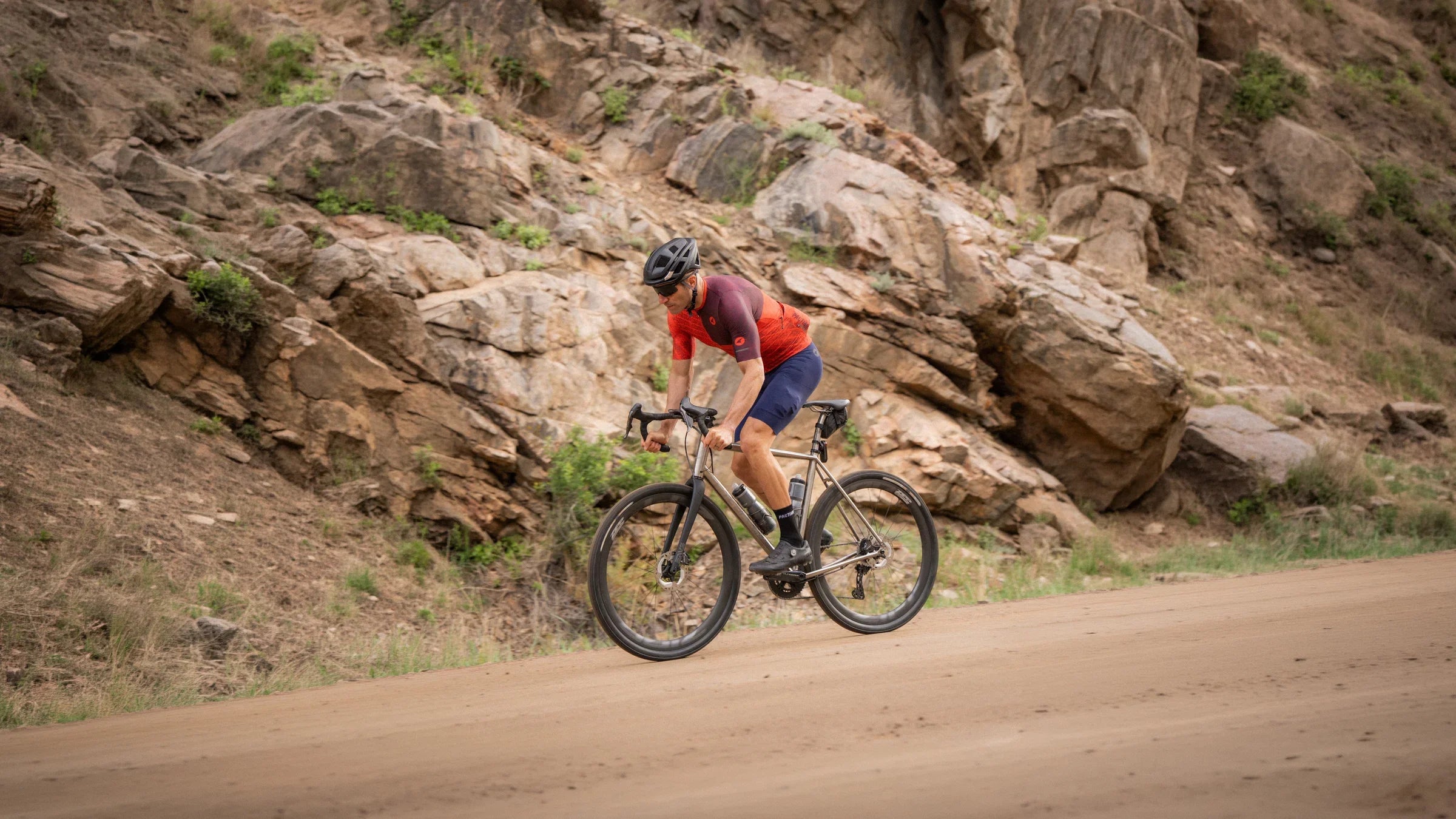 Male cyclist on a dirt road in a canyon