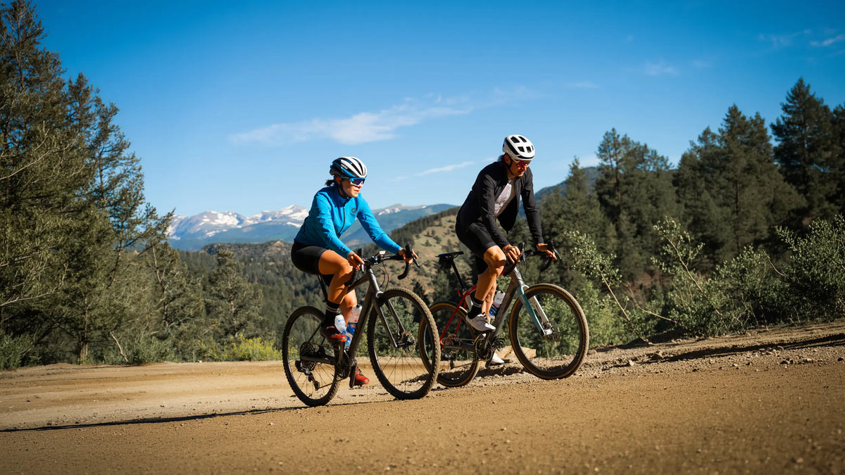 Two cyclists riding on a dirt road in Colorado