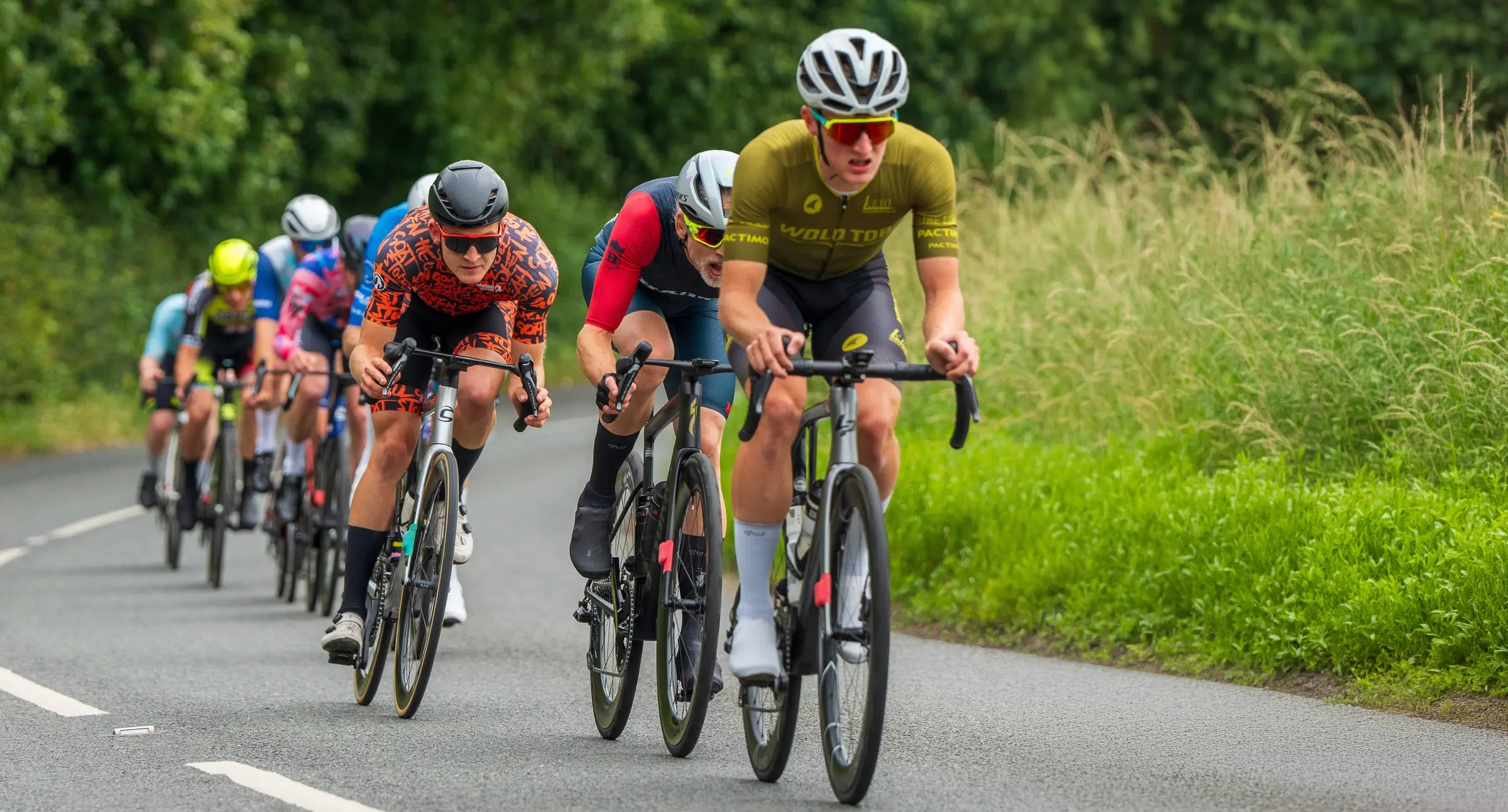 cyclist in Pactimo custom cycling kit leading the pack in a road race