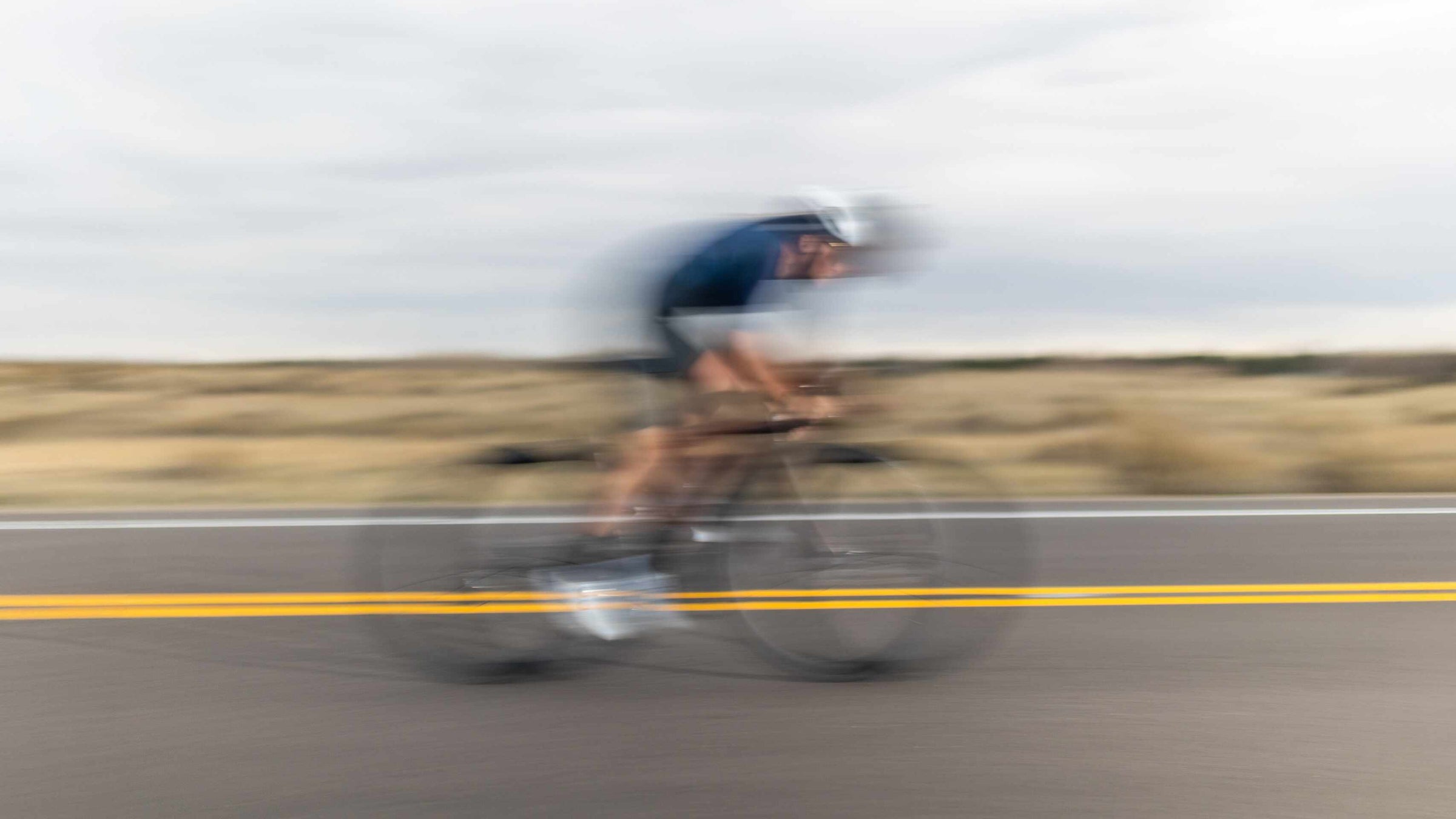 Pactimo Cyclist in motion on a road with a blurred effect