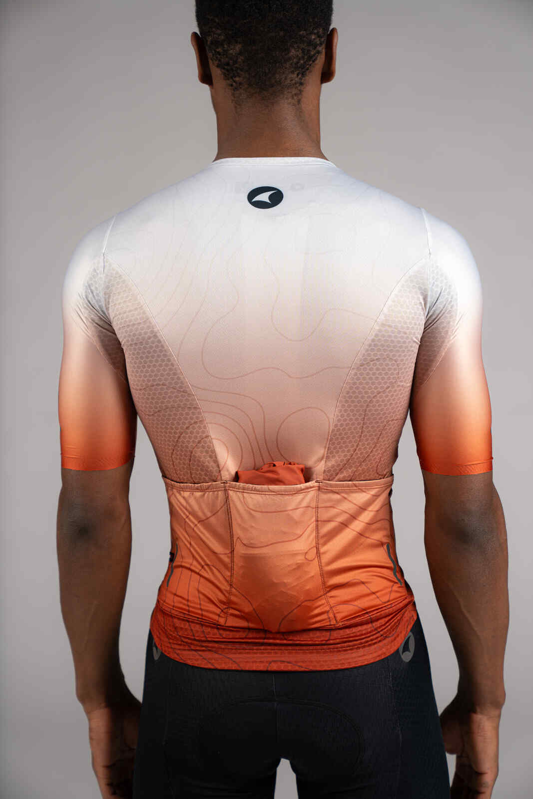 Men's Packable Burnt Orange Cycling Wind Jacket - In Back Pocket