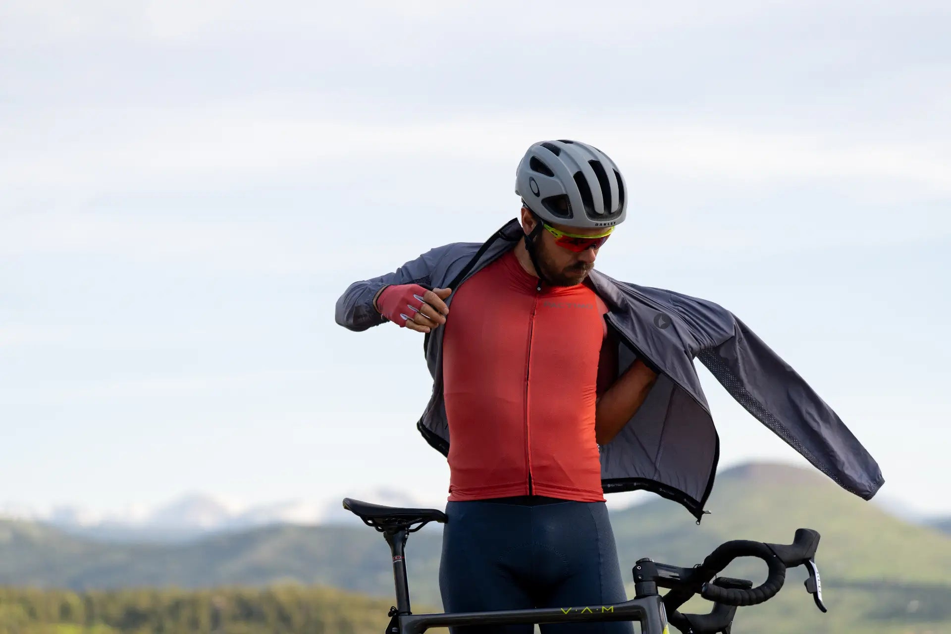 Cyclist putting on a lightweight wind jacket
