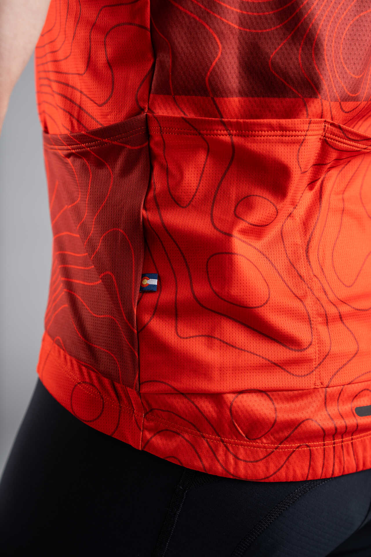 Men's Red Cargo Cycling Jersey in Teal Topo Design - Pocket Close-Up