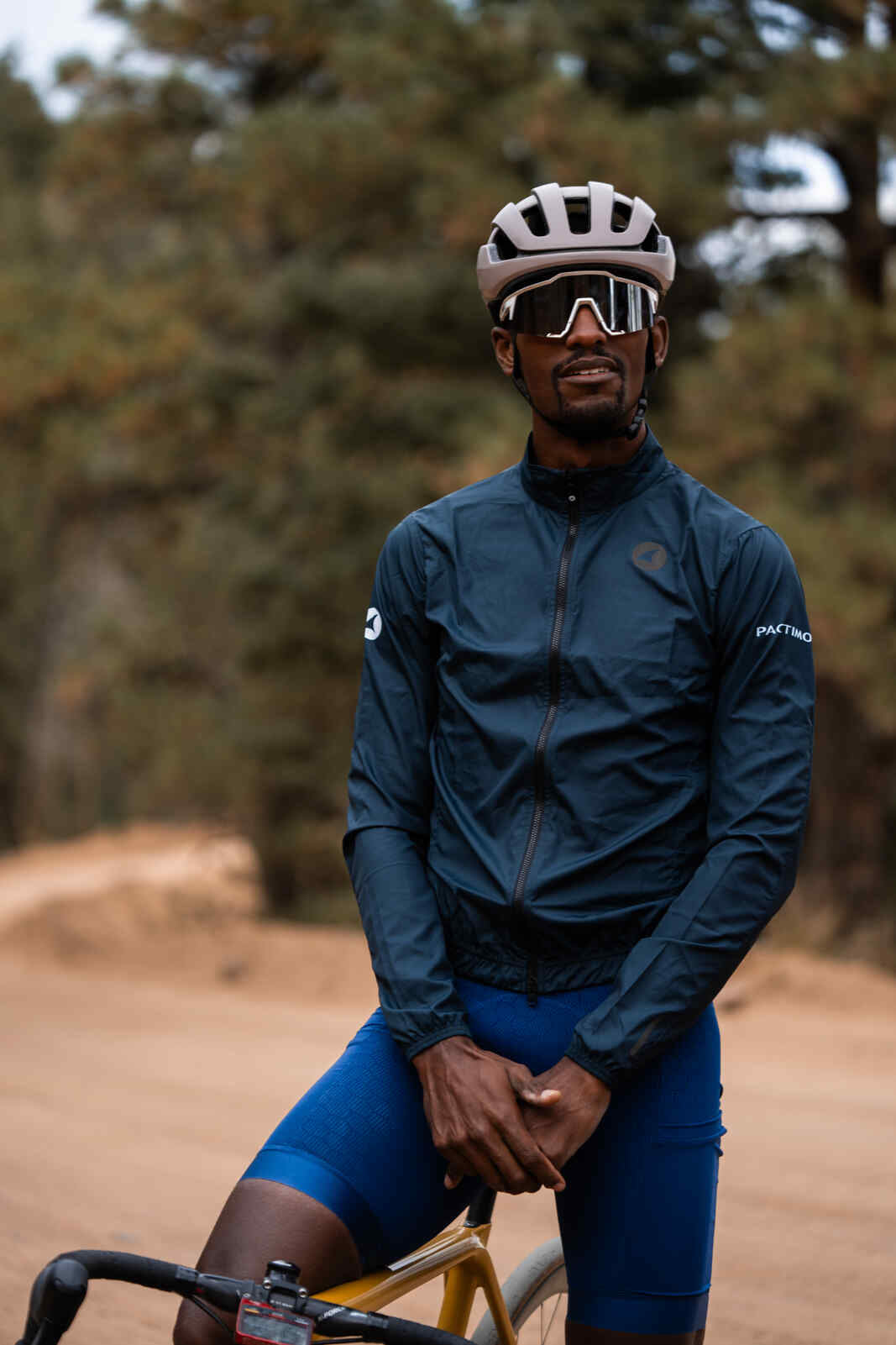 Cyclist in Men's Packable Navy Blue Cycling Wind Jacket 