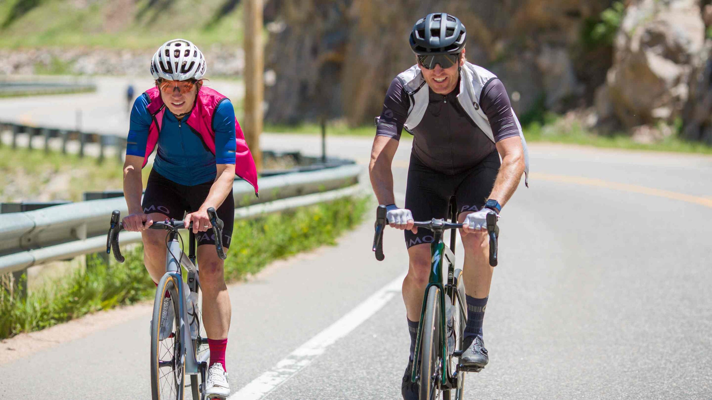 Cyclists in Vests Riding on the Road