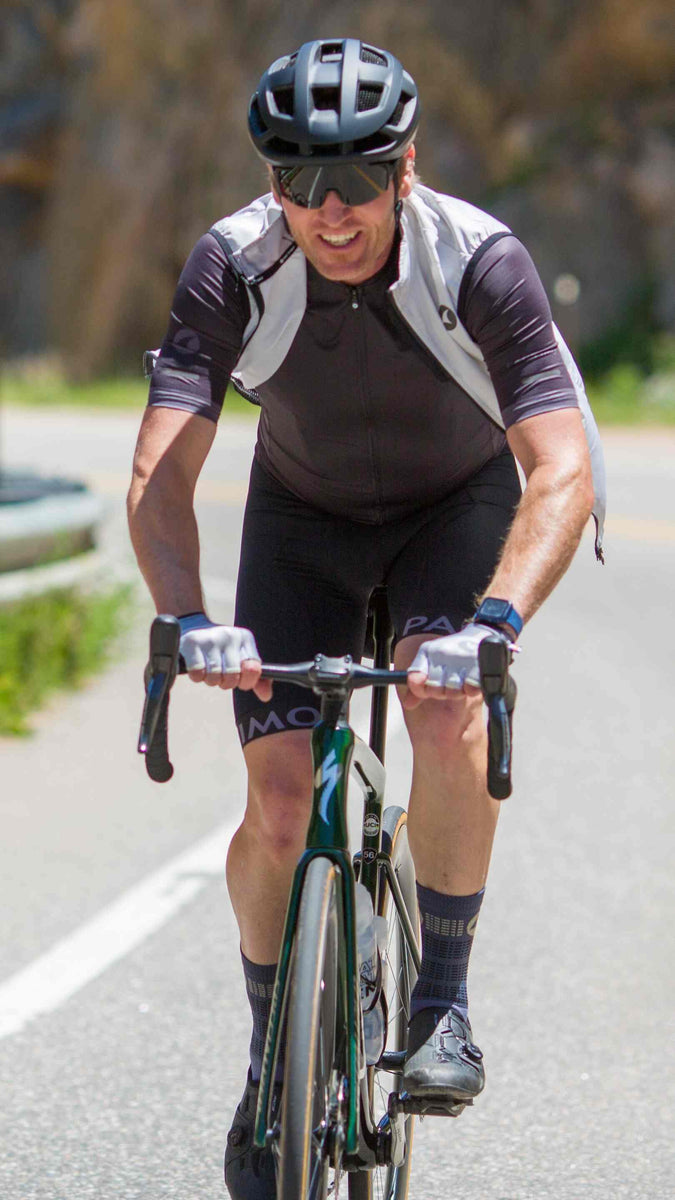 Guy Cyclist in Vest Riding on the Road