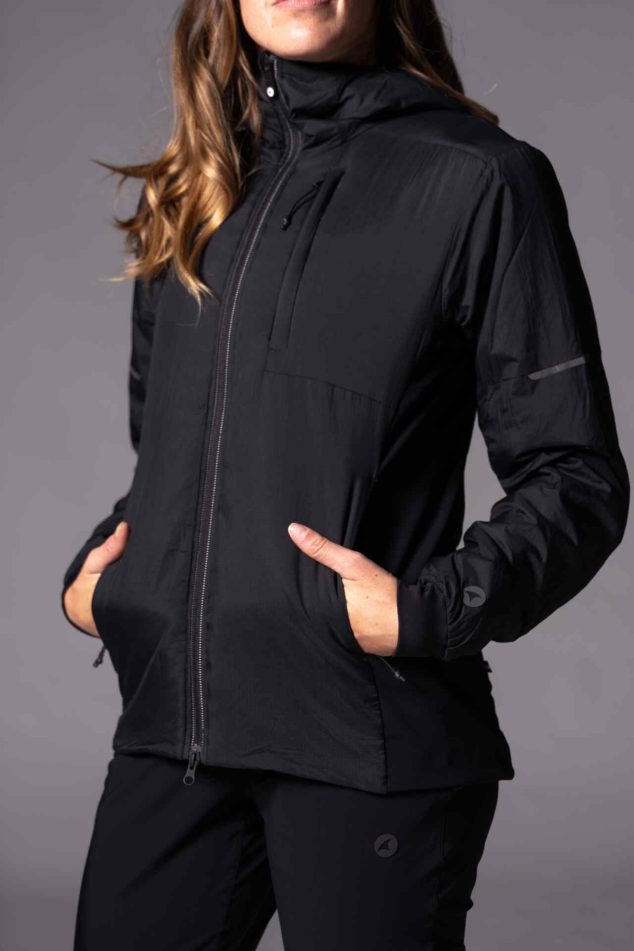 A woman with her hands in pockets of the Prologue Insulated Jacket