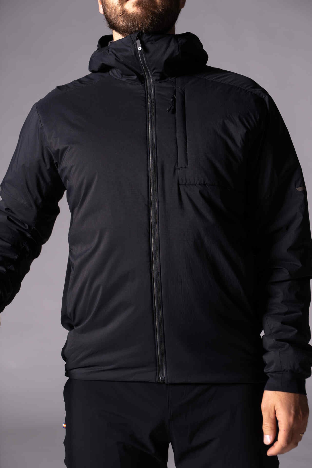 Two-way, reflective zipper allows for comfort and temperature regulation, while zippered hand and chest pockets ensure valuables remain secure.