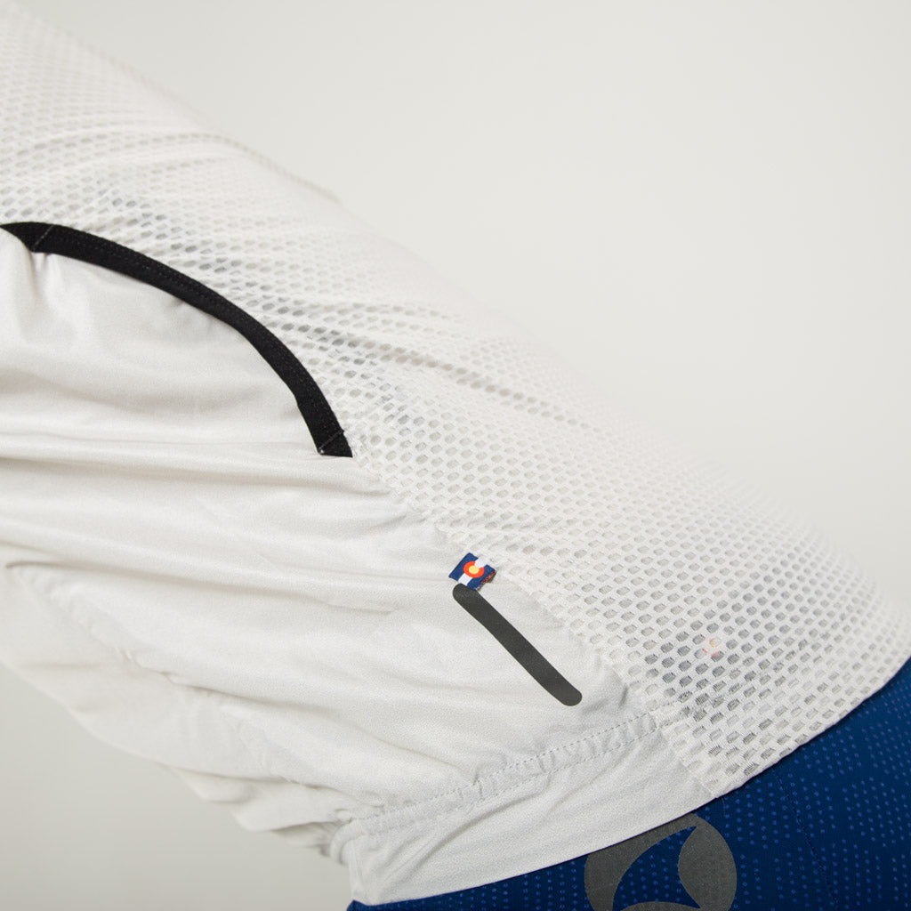Men's Packable Cycling Wind Vest back pocket detail #color_dune