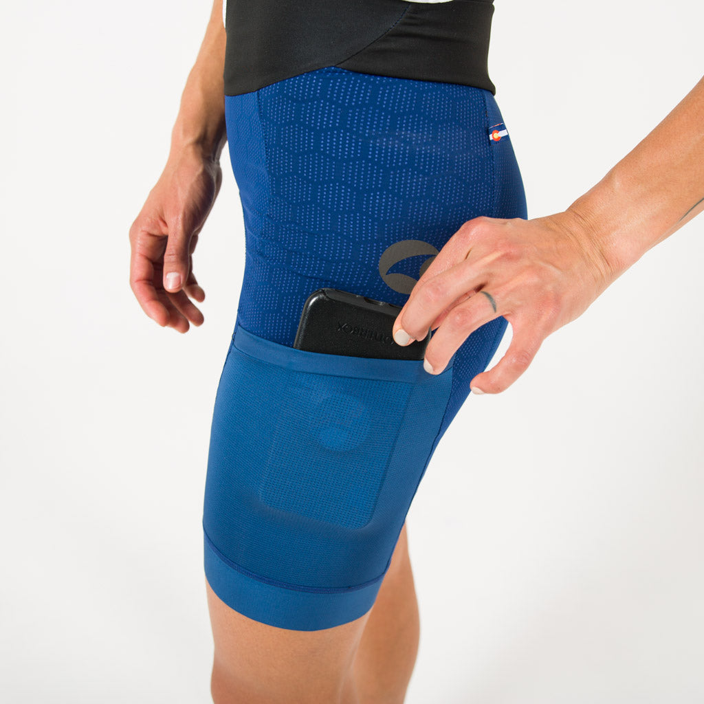 Women's Blue Long Distance Cargo Bib Shorts - Pocket Detail #color_navy